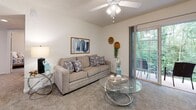 Located at 1911 Saddlebrook Dr in Murfreesboro, Tennessee, this single-floor home offers a well-organized layout designed for comfortable everyday living. The living room serves as the heart of the home, featuring plush carpeting, a ceiling fan with light fixture, and a large sliding glass door that opens to a private outdoor patio overlooking lush, wooded greenery — bringing natural light and serene views indoors.

The kitchen is equipped with warm honey-toned wood cabinetry, white countertops, and a full suite of stainless steel appliances including a gas range, dishwasher, and refrigerator. Wood-look flooring adds a durable, classic touch to this functional cooking space.

The home includes multiple carpeted bedrooms, each featuring ceiling fans, large windows that invite natural light, and closet access. The primary bedroom is well-proportioned with a window overlooking the surrounding neighborhood. Additional bedrooms offer cozy, versatile spaces suitable for guests or a home office.

Two bathrooms serve the home, both finished with wood-look tile flooring and warm wood vanities with ample counter space. Each bathroom features a shower/tub combination and clean, neutral finishes throughout.

Overall, the home presents a warm, neutral palette with consistent finishes across all rooms, creating a cohesive and inviting atmosphere throughout.