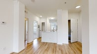 Located at 2242 Gill Village Way in San Diego, CA, this two-bedroom, one-bathroom residence offers a well-designed single-floor layout with a comfortable and functional flow throughout. The open-concept living and dining area features a combination of warm wood-look flooring and plush carpeting, a ceiling fan, and a tiled fireplace that serves as a welcoming focal point. Large windows allow natural light to fill the space, enhancing its bright and airy atmosphere.

The kitchen is thoughtfully designed with white cabinetry, stone-look countertops, stainless steel appliances including a refrigerator, electric range, and microwave, and a peninsula with a sink that opens toward the living area—ideal for both cooking and entertaining.

The primary bedroom is generously sized, carpeted for comfort, and features a ceiling fan and windows with outdoor views of surrounding greenery. The second bedroom is equally bright with its own ceiling fan and closet access. A dedicated walk-in closet adds practical storage.

The bathroom is clean and modern, featuring wood-look flooring, a vanity with a white countertop, a large mirror, and a full tub-shower combination with ample natural light from a nearby window. Overall, the space exudes a light, neutral aesthetic throughout.