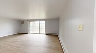 Located at 23462 Lorain Rd in North Olmsted, Ohio, this two-bedroom, one-bathroom residence offers a practical and well-organized single-floor layout. The combined kitchen and living area serves as the heart of the home, with the living room featuring light wood-look laminate flooring, baseboard heating, and a large sliding glass door that fills the space with natural light and provides direct access to a private balcony overlooking the tree-lined neighborhood. The kitchen is equipped with white shaker-style cabinetry, a Whirlpool electric range, a full-size refrigerator, and warm butcher block countertops that add a natural contrast to the clean white palette. Open shelving provides additional storage and character. Both bedrooms are carpeted and finished in neutral tones, each featuring windows that bring in natural light and baseboard heating. The primary bedroom offers a comfortable, dedicated retreat, while the second bedroom provides flexible use. A hallway connects the bedrooms to the shared full bathroom, which includes a white vanity, wood-look flooring, and a tiled shower-tub combination. A dedicated closet and hallway complete the functional layout of this straightforward North Olmsted residence.