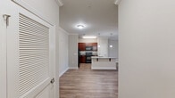 Located at 213 S Park Way in Sanford, NC, this one-bedroom, one-bathroom residence offers a thoughtfully organized layout across a single floor. The kitchen is a standout feature, showcasing rich cherry wood cabinetry, granite countertops, black appliances including a refrigerator, range, and microwave, and a central island with a double stainless steel sink illuminated by pendant lighting. Crown molding adds a refined touch to the kitchen and adjoining living area, which features light hardwood-style flooring that flows throughout the main living spaces. The bedroom is a comfortable retreat with plush carpeting, a ceiling fan, and a window that allows in natural light with views of the surrounding greenery. It includes access to a dedicated closet, providing practical storage. The bathroom is clean and functional, featuring a tub-shower combination with tile flooring and a granite-topped vanity. A hallway connects the rooms with ease. Outside, a private balcony with metal railing overlooks a landscaped courtyard with mature trees, offering a pleasant outdoor retreat. The brick exterior adds classic curb appeal to this well-appointed residence.