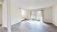 Located at 3402 Water Vista Pky in Lawrenceville, GA, this single-floor residence offers 2 bedrooms and 2 bathrooms within a well-organized, functional layout. The living room is a bright, welcoming space featuring light wood-look flooring and a large sliding glass door that opens to a private patio, flooding the room with natural light and providing outdoor views of surrounding greenery. Adjacent to the living room, the dining area flows seamlessly from the kitchen, which is equipped with a range and white cabinetry, with the same wood-look flooring tying the spaces together cohesively.

The primary bedroom is generously sized, featuring plush carpeting, dual windows with blinds that invite natural light, and a walk-in closet outfitted with dual clothing rods and shelving for ample storage. The second bedroom, also carpeted, offers a comfortable and quiet retreat. Both bathrooms are clean and functional; one features a full soaking tub and shower combination with chrome fixtures, while the other includes wood-look flooring, a vanity with a stone-look countertop, and dark cabinetry. Neutral tones and textured ceilings are consistent throughout, creating a clean and understated aesthetic across the entire home.