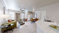Located at 6010 S Westmoreland Rd in Dallas, TX, this well-appointed 2-bedroom, 2-bathroom residence offers a thoughtfully designed single-level layout. The open-concept living and dining area is bright and welcoming, featuring wood-style flooring, crown molding, and a ceiling fan overhead. Multiple windows fill the space with natural light and offer views of the surrounding greenery. The living room flows seamlessly into the dining area, creating an ideal space for both relaxing and entertaining.

The kitchen is a standout feature, equipped with white cabinetry, stainless steel appliances, a subway tile backsplash, and a peninsula with quartz countertops that doubles as a breakfast bar. A pantry provides additional storage convenience.

The primary bedroom is comfortably sized with plush carpeting, a ceiling fan, and a walk-in closet with built-in shelving. The en-suite bathroom features a wide vanity with quartz countertops and a tub-shower combination. The second bedroom, also carpeted, is bright with a natural light-filled window and offers flexible use as a guest room or home office. Both bathrooms are finished with light wood-style flooring and clean, neutral tones. An in-unit laundry area and hallway complete the functional layout.