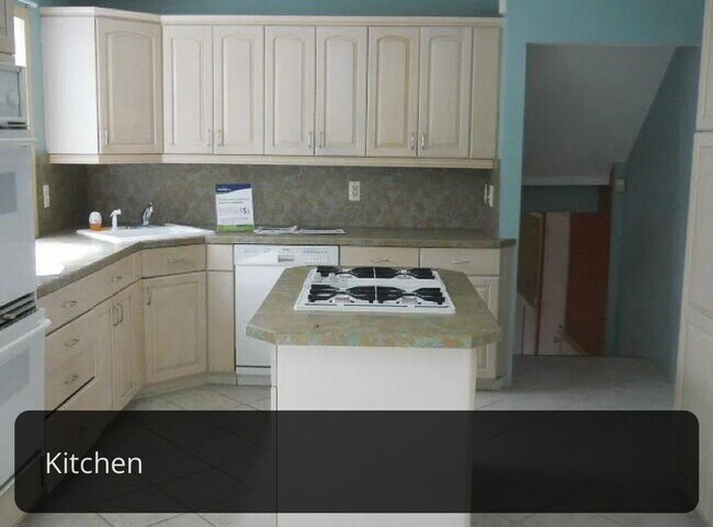 Picture of previous tenants, currently having cabinets updated and new stainless steel appliances. - 412 Orchard St