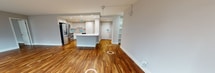 This contemporary 1210 square foot apartment, located at 1819 JFK BLVD in Philadelphia, offers a blend of style and functionality. The space comprises two bedrooms, including a spacious 220 square foot primary bedroom, and two full bathrooms. The open-concept design seamlessly integrates the kitchen and living areas, creating an inviting atmosphere for both relaxation and entertainment.

The apartment boasts high-quality finishes throughout, with beautiful hardwood flooring in the main living areas and bedrooms. Large windows flood the space with natural light and provide stunning views of the surrounding cityscape. The modern kitchen features sleek white cabinetry, a marble-inspired backsplash, and high-end stainless steel appliances, including a French door refrigerator and built-in microwave.

Both bathrooms are well-appointed with neutral-toned tile flooring, white vanities, and glass-enclosed showers. The apartment also includes two closets, one of which is a walk-in with custom shelving and hanging space, offering ample storage solutions.

The unit's single-floor layout enhances accessibility and flow, while the central hallway connects all rooms efficiently. This apartment combines urban sophistication with practical living, making it an ideal residence in the heart of Philadelphia.