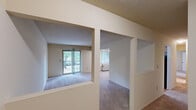 Located at 37140 S Orchard Cir in Westland, Michigan, this two-bedroom, two-bathroom residence offers a practical and well-organized single-floor layout. The open living room is spacious and carpeted, featuring a sliding glass door that allows natural light to pour in and provides access to an outdoor area. A ceiling fan adds comfort to the space, and the room connects seamlessly to the kitchen. The kitchen is equipped with warm oak cabinetry, a granite-style countertop, a double basin sink, a stainless steel dishwasher, and an electric range, all finished with durable hardwood-style flooring. The primary bedroom is generously sized with plush carpeting, a window for natural light, and a built-in closet with bifold doors. The second bedroom also features carpet flooring, a window with outdoor views, and ample wall space. Both bathrooms are clean and functional — one features tile flooring, an oak vanity with a granite-top sink, and a mirror with overhead lighting, while the second includes a tub-shower combination and hardwood-style flooring. Textured ceilings are consistent throughout the home, adding a classic residential feel to every room.