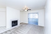 Located at 139 E Cache Point Lane in Draper, Utah, this single-floor, 2-bedroom, 3-bathroom home offers a functional and comfortable layout. The living room serves as the heart of the space, featuring a tile-surround wood-burning fireplace, a ceiling fan with light fixture, and a sliding glass door with vertical blinds that fills the room with natural light and provides outdoor access. Carpet flooring runs throughout the main living areas and bedrooms, contributing to a warm, cozy ambiance.

The kitchen is well-appointed with white cabinetry, ample counter space with neutral laminate countertops, a built-in microwave, an electric range, a dishwasher, and tile flooring — offering a clean, efficient workspace. A hallway connects the living areas to the private bedrooms and bathrooms.

The primary bedroom is generously sized and includes a walk-in closet equipped with wire shelving for organized storage. Its en-suite vanity area features a wide countertop, white cabinetry, and a large wall mirror with bright overhead lighting. The additional bathrooms are well-designed, each with a single-sink vanity, tile flooring, and a shower-tub combination. The dedicated laundry room includes a full-size washer and dryer and features wood-look flooring and wire shelving above.