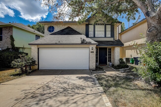 Front of the house with 2 car garage and driveway - 8645 Piney Creek Bend