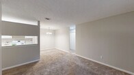 This single-story, two-bedroom, two-bathroom home in Columbus, Georgia offers a practical and comfortable layout. The galley-style kitchen is well-appointed with white cabinetry, light countertops, a built-in sink, and white appliances including a range and refrigerator, all set atop durable wood-look flooring that adds warmth to the space. The open living area is carpeted and features a sliding glass door dressed with vertical blinds, filling the room with natural light while providing outdoor access. Both bedrooms are generously sized, finished with plush carpet and neutral walls that create a calm, inviting atmosphere. Each bedroom is equipped with a ceiling fan and light fixture, and benefits from natural light through window blinds. The primary bedroom offers a spacious feel, complemented by a dedicated closet. Two full bathrooms each feature a tub-shower combination, maintaining a clean, functional aesthetic with neutral tones and wood-look flooring. Two closets throughout the home provide ample storage. The consistent use of neutral tones, carpet in living and sleeping areas, and wood-look flooring in wet areas ties the space together cohesively, making it a move-in ready home in a convenient Columbus location.