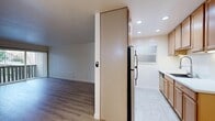 Located at 111 Cleaveland Rd in Pleasant Hill, CA, this one-bedroom, one-bathroom unit offers a practical and well-organized single-floor layout. The combined kitchen and living area forms the heart of the home, with warm wood-style flooring extending throughout. The living room is bright and open, featuring a wall-mounted HVAC unit and a sliding glass door that opens to a private balcony, allowing natural light and outdoor views to flow in. The kitchen is efficiently designed with warm wood cabinetry, recessed lighting, light tile flooring, a stainless steel sink, and a dishwasher, providing ample storage and counter space. A full-size refrigerator is also included. The bedroom is a well-proportioned, quiet retreat with a large window offering natural light and outdoor greenery views, complemented by a baseboard heater and its own closet with a sliding door. The bathroom features a full tub-shower combination with clean white tile surround and chrome fixtures. Throughout the unit, neutral tones, clean white walls, and consistent flooring create a cohesive, move-in-ready ambiance suited for comfortable everyday living.