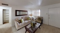 This single-story residence in Fort Worth, Texas offers a well-organized and functional layout designed for comfortable everyday living. The living room serves as the heart of the home, featuring plush carpeting, plantation shutters that filter natural light, and ample space for seating and relaxation. A large wall mirror enhances the sense of openness in this inviting area.

Adjacent to the living room, the dedicated dining area is an intimate space highlighted by an elegant chandelier overhead and warm-toned framed artwork on the walls, creating an ideal setting for shared meals.

The galley-style kitchen is efficiently designed with wood-toned cabinetry lining both sides, white countertops, a double-coil electric range, built-in microwave, refrigerator, dishwasher, and a stainless steel sink — all complemented by tile flooring underfoot.

Both bedrooms are carpeted and feature ceiling fans with integrated lighting. The primary bedroom is generously sized, offering direct access to a private bathroom. The bathroom includes a broad vanity with white cabinetry, a large mirror framed by Hollywood-style lighting, and plush carpeting, lending the space a clean, functional aesthetic throughout.