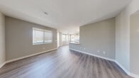 Located at 2750 W Wigwam Ave in Las Vegas, Nevada, this well-designed 2-bedroom, 2-bathroom residence offers a thoughtfully laid-out single-floor plan with modern finishes throughout. The open-concept living and kitchen area serves as the heart of the home, featuring light wood-style plank flooring, neutral gray tones, and an abundance of natural light streaming through multiple windows fitted with horizontal blinds. The kitchen is outfitted with crisp white cabinetry, light quartz-style countertops, a peninsula with an undermount sink, and a full suite of stainless steel appliances including a gas range, microwave, and dishwasher. The living area flows seamlessly from the kitchen, offering a spacious and airy feel ideal for both relaxing and entertaining. The primary bedroom is generously sized and features a walk-in closet with wire shelving for ample storage. The second bedroom includes a standard closet and large window for natural light. Both bathrooms are finished with white shaker-style vanities, quartz countertops, wood-style flooring, and a shower/tub combination. A dedicated hallway connects the bedrooms, and a ceiling fan adds comfort to the primary living spaces. The overall aesthetic is clean, contemporary, and move-in ready.