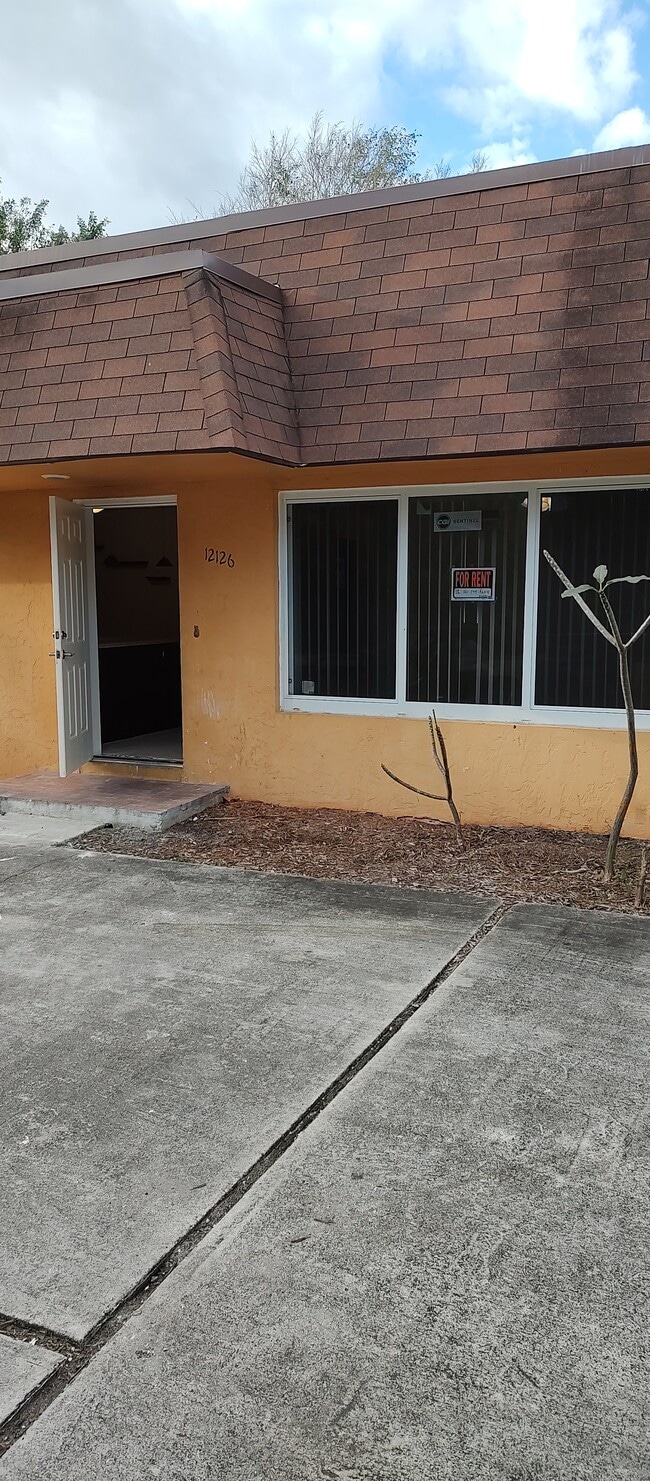 View of front door from parking lot - 12126 Gibbs Rd Apartments