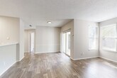 Located at 4501 Bentley Dr in Columbia, SC, this single-floor, 3-bedroom, 2-bathroom home offers a thoughtfully organized layout designed for comfortable everyday living. The living room serves as the heart of the home, showcasing wood-look plank flooring, a textured ceiling, and a tile-surround fireplace flanked by windows that allow natural light to fill the space. Sliding glass doors provide access to an outdoor area, further enhancing the open, airy feel. The kitchen features white cabinetry, a peninsula with a light countertop, and a skylight-style flush fixture overhead, creating a bright and functional workspace. A dedicated laundry area is conveniently accessible from the kitchen. The three bedrooms are carpeted for warmth and comfort, each offering closet storage and natural light through window blinds. The primary bedroom provides a comfortable, well-proportioned retreat. Both bathrooms are finished with clean white tile tub-shower combinations and chrome fixtures. A central hallway connects the bedrooms and bathrooms, while five closets throughout the home ensure ample storage. The neutral color palette and consistent finishes create a cohesive and move-in-ready atmosphere throughout.