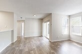 Located at 4501 Bentley Dr in Columbia, SC, this single-floor, 3-bedroom, 2-bathroom home offers a thoughtfully organized layout designed for comfortable everyday living. The living room serves as the heart of the home, showcasing wood-look plank flooring, a textured ceiling, and a tile-surround fireplace flanked by windows that allow natural light to fill the space. Sliding glass doors provide access to an outdoor area, further enhancing the open, airy feel. The kitchen features white cabinetry, a peninsula with a light countertop, and a skylight-style flush fixture overhead, creating a bright and functional workspace. A dedicated laundry area is conveniently accessible from the kitchen. The three bedrooms are carpeted for warmth and comfort, each offering closet storage and natural light through window blinds. The primary bedroom provides a comfortable, well-proportioned retreat. Both bathrooms are finished with clean white tile tub-shower combinations and chrome fixtures. A central hallway connects the bedrooms and bathrooms, while five closets throughout the home ensure ample storage. The neutral color palette and consistent finishes create a cohesive and move-in-ready atmosphere throughout.
