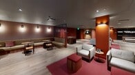 Located at 1701 Market St in the heart of Philadelphia, this single-floor amenity space offers a generously sized, thoughtfully designed environment suited for socializing, dining, and recreation. The interior is defined by a bold color palette of deep terracotta and burgundy red walls, set against light-toned hardwood flooring that runs throughout the open-plan layout, creating a warm yet contemporary atmosphere.

The main lounge area features a variety of seating arrangements, including plush white armchairs, a long upholstered green banquette with round wooden tables, and scattered accent chairs — all anchored by rich red area rugs. A curated reading nook with wall-mounted magazine racks and warm sconce lighting adds a relaxed, intimate corner to the space. A shuffleboard table and dartboard provide additional entertainment options.

The bar area is highlighted by pendant lighting and bar-height seating along a dark stone countertop, complemented by floor-to-ceiling frosted glass partitions. A private meeting or dining room features a sleek wooden conference table, lounge chairs, and glass-walled access to an elevator corridor.

The fully equipped kitchen includes light maple cabinetry, dark granite countertops, stainless steel appliances — including double wall ovens, a large refrigerator, and a range hood — with white subway tile backsplash and skylight above. A secondary kitchenette area provides additional prep space with granite counters and a dishwasher.