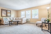 Located at 415 Moorland Rd in Madison, WI, this single-floor, 2-bedroom, 1-bathroom residence offers a practical and comfortable layout. The entryway welcomes you into a well-organized floor plan with distinct living and dining areas. The living room is generously sized, featuring neutral carpet, warm beige walls, and a bright window that invites natural light. Adjacent to it, the dining area features hardwood-style flooring and a cozy nook ideal for intimate meals. The kitchen is efficiently designed in a galley style, equipped with warm oak cabinetry, dark countertops, black appliances including an electric range and refrigerator, and a tile backsplash accent — with direct access to the entrance. The primary bedroom is a well-proportioned retreat with dual windows, a ceiling fan, and plush carpeting, while the second bedroom offers comfortable proportions and its own window with natural light. The full bathroom features hardwood-style flooring, warm wood cabinetry, a long white countertop with dual mirrors, and a separate tub-shower combination. A dedicated closet with dual hanging rods provides ample storage. Baseboard heating is present throughout the home.