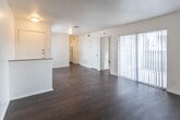 Located at 3843 Penbrook St in Odessa, Texas, this single-story unit offers a straightforward and functional layout suited for comfortable everyday living. The entryway opens into a spacious main living area finished with rich, dark hardwood-style flooring that extends throughout the common spaces, creating a warm and cohesive feel. A half-wall partition adds a subtle architectural detail that defines the living space without interrupting its open character. Natural light enters through vertical-blind-covered windows, keeping the interior bright and airy.

The kitchen is efficiently designed with white cabinetry, granite-look countertops, a double stainless steel sink, and a white appliance suite including a range and refrigerator. Dark hardwood-style flooring continues here, and a window above the sink provides additional natural light.

The bedroom is carpeted for comfort and features direct access to a walk-in closet, offering ample storage. An adjacent full bathroom includes a tub-shower combination with chrome fixtures, a toilet, and a vanity with matching countertops and dark hardwood-style flooring. The neutral white walls throughout the unit provide a clean, move-in-ready canvas adaptable to a variety of décor styles.