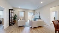 This well-appointed single-story home showcases a thoughtfully designed open-concept layout that seamlessly connects the main living spaces. The kitchen is a standout feature, equipped with stainless steel appliances including a refrigerator with ice dispenser, electric range, microwave, and dishwasher. Crisp white shaker cabinetry, a classic subway tile backsplash, granite countertops, and a peninsula with bar seating complete the space, all set atop durable light wood-tone luxury vinyl plank flooring that extends throughout the home.

The living room is bright and welcoming, with recessed lighting, large windows dressed with blinds and drape panels, and a sliding glass door that opens directly to a private, fenced backyard with a grassy area — ideal for indoor-outdoor living.

The primary bedroom offers generous natural light through large windows, while the en-suite bathroom features a glass-enclosed walk-in shower, granite vanity countertops, and white cabinetry. Additional bedrooms provide comfortable accommodations, including a well-sized secondary bedroom. The secondary bathroom includes a tub-shower combination, granite vanity, and a bright window. Consistent light flooring and neutral wall tones throughout create a cohesive, modern aesthetic.
