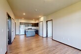 Located at 315 N Worthen St in Wenatchee, WA, this well-appointed two-bedroom, two-bathroom unit offers a functional and modern layout across a single floor. The open-concept kitchen and living area serves as the heart of the home, featuring dark espresso cabinetry, light quartz countertops, stainless steel appliances including a refrigerator, range, microwave, and dishwasher, as well as a center island ideal for casual dining or meal prep. Light wood-style flooring flows throughout the main living areas, creating a warm and cohesive aesthetic. The living area is bright and airy, with access to a private balcony and large windows that frame picturesque views of the rolling hills surrounding Wenatchee. Both bedrooms are carpeted and generously sized, each benefiting from natural light and the same scenic hillside views. The primary bedroom offers a comfortable retreat with a well-proportioned layout. The two bathrooms are clean and functional, each featuring a tub/shower combination, hardwood-style flooring, and chrome fixtures. A dedicated closet provides additional storage. The unit's overall design balances modern finishes with practical livability, making it a comfortable home in the heart of Wenatchee.