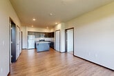 Located at 315 N Worthen St in Wenatchee, WA, this well-appointed two-bedroom, two-bathroom unit offers a functional and modern layout across a single floor. The open-concept kitchen and living area serves as the heart of the home, featuring dark espresso cabinetry, light quartz countertops, stainless steel appliances including a refrigerator, range, microwave, and dishwasher, as well as a center island ideal for casual dining or meal prep. Light wood-style flooring flows throughout the main living areas, creating a warm and cohesive aesthetic. The living area is bright and airy, with access to a private balcony and large windows that frame picturesque views of the rolling hills surrounding Wenatchee. Both bedrooms are carpeted and generously sized, each benefiting from natural light and the same scenic hillside views. The primary bedroom offers a comfortable retreat with a well-proportioned layout. The two bathrooms are clean and functional, each featuring a tub/shower combination, hardwood-style flooring, and chrome fixtures. A dedicated closet provides additional storage. The unit's overall design balances modern finishes with practical livability, making it a comfortable home in the heart of Wenatchee.