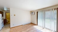 Located at 1670 Western Avenue in Green Bay, Wisconsin, this one-bedroom, one-bathroom unit offers a efficient, single-floor layout designed for comfortable everyday living. Light wood flooring flows consistently throughout the main living areas, creating a warm and cohesive feel across the space.

The living room is bright and open, featuring a sliding glass door dressed with vertical blinds that allows natural light to pour in and provides access to the outdoors. A wall-mounted air conditioning unit and baseboard heating ensure year-round climate control. A dedicated entryway with tile flooring and two interior doors provides a practical transition into the main living area.

The bedroom is a well-proportioned retreat with the same light wood flooring, a window that brings in natural light, and a double sliding-door closet offering generous storage. Baseboard heating keeps the room comfortable throughout Wisconsin's colder months.

The kitchen features white appliances, including a range and refrigerator, with wood-toned cabinetry providing ample storage. The full bathroom is finished with tile flooring, a single-sink vanity with wood cabinetry, a large mirror, and a tub/shower combo with a clean, neutral surround. Overall, the unit presents a tidy, functional layout well-suited for single occupancy or a couple.
