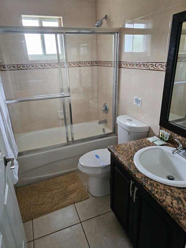 This bathroom is shared with the queen size bedroom and the full bedside bedroom - 7702 NE 3rd Ct
