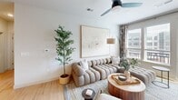 This contemporary 970 square foot apartment in Metuchen, NJ, offers a harmonious blend of style and functionality. The space comprises three bedrooms and three bathrooms, with the primary bedroom spanning a generous 170 square feet. The open-concept design seamlessly integrates the kitchen and living area, creating a spacious feel despite the compact footprint.

The kitchen boasts sleek white cabinetry, contrasting with stainless steel appliances and a unique patterned floor. Modern amenities include a built-in microwave and a French door refrigerator. The living room features a plush, channel-tufted sofa, complemented by natural elements like potted plants and wooden accents.

Each bedroom is thoughtfully designed, with the primary bedroom showcasing a minimalist aesthetic and nature-inspired artwork. The bathrooms maintain a consistent modern theme with clean lines, floating vanities, and artistic touches.

Large windows throughout allow ample natural light and offer urban views, enhancing the apartment's bright and airy ambiance. The clever use of space is evident in the inclusion of a home office area and ample storage solutions. Hardwood floors unify the space, while carefully chosen decor and artwork add personality to each room, creating a sophisticated yet comfortable living environment.