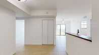 Located at 5225 Northwest 29th Avenue in Miami, FL, this two-bedroom, one-bathroom residence offers a well-organized single-floor layout designed for comfortable everyday living. Light-toned ceramic tile flooring runs consistently throughout the space, contributing to a clean, cohesive aesthetic.

The open-concept living and dining area is bright and airy, with a ceiling fan overhead and sliding glass doors that lead to a private balcony, allowing natural light to flow through the space. The kitchen features warm wood-tone cabinetry, dark granite-style countertops, a peninsula with a double sink, and a full suite of appliances including a range, built-in microwave, and refrigerator — making it both practical and visually connected to the main living area.

Both bedrooms are well-proportioned, each equipped with ceiling fans, natural light from windows with blinds, and generous closet space via bi-fold doors. The primary bedroom includes a notably spacious closet configuration. A hallway lined with multiple closets provides exceptional storage throughout.

The bathroom is fully equipped with a tub-shower combination, accessibility grab bars, a granite-topped vanity with wood cabinetry, and tile surround. A dedicated laundry area and in-unit electrical panel add to the home's overall functionality. The space is thoughtfully designed to maximize utility within a compact Miami footprint.