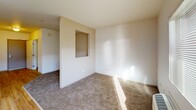 Located at 875 Cinnabar St in San Jose, CA, this one-bedroom, one-bathroom unit offers a practical and well-organized layout across a single floor. The galley-style kitchen is a standout feature, equipped with warm wood cabinetry, granite-look countertops, a double basin sink, and white appliances including a dishwasher, electric range, and refrigerator. Light wood-style flooring runs throughout the kitchen, transitioning to soft carpet in the living area, which benefits from natural light streaming through a large window and a glass door leading to a private balcony. A built-in wall niche adds a subtle architectural detail to the living space. The bedroom is a comfortable size, featuring plush carpet and ample natural light. The bathroom is cleanly appointed with wood-look flooring, a wall-mounted sink, a medicine cabinet mirror, and a shower-tub combo. An in-unit laundry area adds everyday convenience. A hallway connects the main spaces, contributing to a logical and efficient flow throughout the unit.