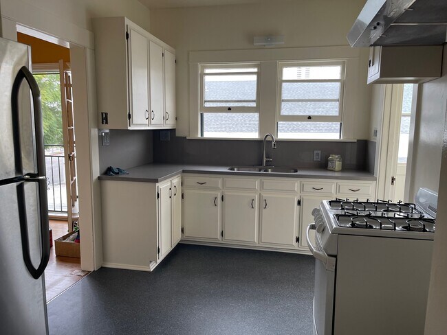 Kitchen with stove and refrigerator - 2444 Griffin Ave