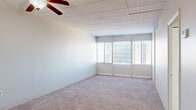 Located at 726 Washington St in Reading, PA, this one-bedroom, one-bathroom unit offers a thoughtfully laid-out single-floor plan with a comfortable sense of space. The living room is generously proportioned, featuring wall-to-wall carpeting, a ceiling fan with light fixture, and a bank of large windows fitted with blinds that invite abundant natural light while providing views of the surrounding cityscape. The tile drop ceiling adds a distinctive character to the space. The kitchen is outfitted with white shaker-style cabinetry, marble-look countertops, wood-look vinyl flooring, and a full-size refrigerator, offering a clean and functional cooking area. The bedroom is a comfortable retreat with soft carpeting, a ceiling fan, a closet with double doors, and windows that frame outdoor views. With six closets throughout the unit, storage is plentiful. The bathroom features a tiled tub-shower combination, a toilet, wood-look vinyl flooring, and a vanity with countertop space. The neutral color palette and bright, open feel throughout the unit create a calm and practical living environment well-suited for everyday comfort.