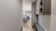 Located at 1805 S Bannock St in Denver, Colorado, this well-appointed two-bedroom, two-bathroom residence offers a thoughtfully designed single-floor layout with modern finishes throughout. The kitchen serves as a central highlight, featuring light wood-tone cabinetry that extends to the ceiling, stainless steel appliances including a side-by-side refrigerator, electric range, and built-in microwave, plus a large island with pendant lighting and durable wood-style flooring. Both bathrooms are finished with wood-look LVP flooring. The primary bathroom includes an extended vanity with a wide mirror and a tub with shower, while the secondary bathroom offers a clean walk-in shower. The two bedrooms are carpeted for comfort; the primary bedroom is generously sized and features dual corner windows that bring in abundant natural light, along with a ceiling fan. The second bedroom includes a ceiling fan and direct access to a private outdoor entrance. Each bedroom is served by its own dedicated closet with built-in shelving and hanging rods. Neutral tones and clean lines carry throughout the space, creating a cohesive, contemporary aesthetic well-suited for comfortable daily living in Denver's vibrant South Broadway neighborhood.