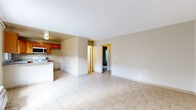 Located at 8742 Orion Ave in Los Angeles, CA, this 2-bedroom, 1-bathroom single-floor unit offers a practical and efficiently laid-out living space. Light-toned ceramic tile flooring runs consistently throughout the home, lending a clean, cohesive look to every room.

The open living area is bright and simply appointed, with neutral beige walls and a straightforward entry door. It flows naturally toward the kitchen, which features warm honey-toned wood cabinetry, granite-style countertops, a gas range, built-in microwave, and a sink positioned beneath a window that brings in natural light. A peninsula counter separates the kitchen from the adjacent living space, adding functional versatility.

The two bedrooms are calm and understated, each finished with the same tile flooring and neutral walls. The bedrooms benefit from windows that allow natural light to filter in, and each is equipped with a sliding-door closet, providing practical storage. A hallway connects the main living areas to the bedrooms and bathroom.

The bathroom is well-appointed with a wood-framed vanity, granite countertop, and a tiled tub-shower combination featuring earth-toned wall tiles and chrome fixtures. Overall, the space presents a functional and straightforward layout well-suited for comfortable everyday living in the North Hills neighborhood of Los Angeles.