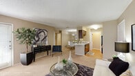 Located at 1901 W Spring Creek Pkwy in Plano, TX, this one-bedroom, one-bathroom unit offers a well-designed single-floor layout that maximizes every square foot. The open-concept living and dining area serves as the heart of the home, featuring warm neutral tones, soft carpet flooring, and a classic brick wood-burning fireplace flanked by windows that invite natural light. The living room flows seamlessly into the dedicated dining space, which is finished with carpet and an overhead pendant light.

The galley-style kitchen is outfitted with rich dark cabinetry, light quartz-style countertops, black appliances including a refrigerator, electric range, and dishwasher, and durable hardwood-style flooring. A breakfast bar connects the kitchen to the main living area, and an adjacent pantry provides generous storage. A pass-through hallway leads to the laundry area for added convenience.

The bedroom is a comfortable retreat with plush carpet, a ceiling fan with light, and a walk-in closet. A second closet offers additional storage. The full bathroom features dark wood cabinetry, a light countertop, a large mirror, a tub-shower combination, and hardwood-style flooring. The thoughtful layout and warm finishes throughout create a cohesive and inviting living environment.