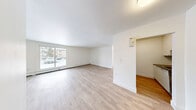Located at 109-123 Westwood Dr in Kitchener, Ontario, this well-appointed 2-bedroom, 1-bathroom unit offers a clean, modern living environment across a single floor. Light hardwood-style flooring runs throughout, complementing the crisp white walls and creating a bright, cohesive aesthetic.

The spacious living area is bathed in natural light through large sliding and picture windows that offer views of the surrounding neighbourhood. Baseboard heating runs along the exterior walls, providing efficient warmth throughout.

The kitchen is thoughtfully designed with white shaker-style cabinetry, dark countertops, a classic white subway tile backsplash, and stainless steel appliances including a refrigerator and dishwasher. A stainless steel sink with a modern faucet completes the functional layout.

Both bedrooms are well-proportioned, with the primary bedroom offering generous space, large windows for natural light, and panel-style closet doors. The second bedroom maintains the same clean finishes found throughout the unit.

The bathroom features a full soaker tub and shower combo lined with white subway tile, a modern vanity with storage, and warm tile flooring. A dedicated entrance provides a practical transition into the main living areas. Overall, the unit presents a fresh, updated interior ideal for comfortable everyday living.