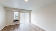 Located at 4719 W Garden Springs Rd in Spokane, WA, this apartment offers a well-designed single-floor layout with three bedrooms and two bathrooms. The living room features light wood-style flooring, neutral walls, and a sliding glass door flanked by a window, allowing natural light to fill the space. A wall-mounted HVAC unit provides in-unit climate control.

The kitchen flows directly into the dining area, connected by a granite-topped breakfast bar with dark wood cabinetry. Pendant lighting hangs above the dining space, which continues the light wood flooring for a cohesive look.

The bedrooms offer a comfortable, quiet retreat. The primary bedroom includes plush carpeting, a closet, and a window with outdoor views. Additional bedrooms also feature carpet flooring and neutral tones, keeping the spaces bright and versatile.

Both bathrooms are finished consistently, with granite-topped vanities featuring dark wood cabinetry, tile surround tub-shower combos with chrome fixtures, and wood-style flooring. The overall design throughout the unit is clean and modern, with a neutral color palette that creates a bright, move-in-ready atmosphere suitable for a variety of living arrangements.