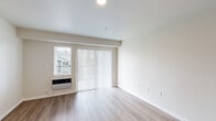 Located at 4719 W Garden Springs Rd in Spokane, WA, this apartment offers a well-designed single-floor layout with three bedrooms and two bathrooms. The living room features light wood-style flooring, neutral walls, and a sliding glass door flanked by a window, allowing natural light to fill the space. A wall-mounted HVAC unit provides in-unit climate control.

The kitchen flows directly into the dining area, connected by a granite-topped breakfast bar with dark wood cabinetry. Pendant lighting hangs above the dining space, which continues the light wood flooring for a cohesive look.

The bedrooms offer a comfortable, quiet retreat. The primary bedroom includes plush carpeting, a closet, and a window with outdoor views. Additional bedrooms also feature carpet flooring and neutral tones, keeping the spaces bright and versatile.

Both bathrooms are finished consistently, with granite-topped vanities featuring dark wood cabinetry, tile surround tub-shower combos with chrome fixtures, and wood-style flooring. The overall design throughout the unit is clean and modern, with a neutral color palette that creates a bright, move-in-ready atmosphere suitable for a variety of living arrangements.