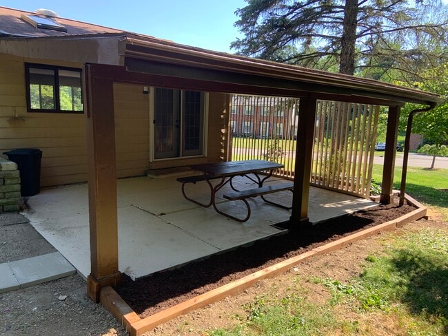 Covered porch with a private tree lined backyard - 900 Tottenham Dr