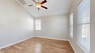 Located at 1501 Flatwood St in Murrells Inlet, SC, this well-appointed single-story, 2-bedroom, 2-bathroom home offers a thoughtfully designed layout with clean finishes throughout. Light-toned hardwood-style flooring flows seamlessly across the entire home, complementing the neutral gray walls and white trim that give the space a bright, cohesive feel.

The open kitchen is a standout feature, showcasing crisp white cabinetry, granite countertops, a full suite of stainless steel appliances — including a refrigerator, range, microwave, and dishwasher — and a window above the sink that invites natural light. The adjacent living area features soaring vaulted ceilings with a ceiling fan and large windows that fill the room with sunshine.

The primary bedroom benefits from vaulted ceilings, a ceiling fan, multiple windows, and a dedicated closet. Its en-suite bathroom includes a glass-enclosed walk-in shower, white vanity cabinetry with granite countertops, and a large mirror. The second bedroom also offers vaulted ceilings, a ceiling fan, and ample closet space. The second bathroom features a full shower-tub combo. A dining area off the kitchen provides additional natural light through dual windows, completing this comfortable and functional home.