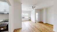 Located in the Koreatown neighborhood of Los Angeles, this single-floor unit at 861 Fedora St offers a clean, move-in-ready interior with a bright and airy atmosphere. Warm-toned hardwood floors extend throughout the entire space, creating a cohesive and inviting feel from room to room.

The main living area is generously proportioned, featuring crisp white walls, crown molding, a ceiling fan with light fixture, and a wall-mounted AC unit. Natural light filters in through multiple windows, enhancing the open feel of the space. A charming arched doorway leads into additional rooms, adding a classic architectural detail to the otherwise modern interior.

The kitchen is efficiently designed with white shaker-style cabinetry, quartz countertops, a stainless steel single-basin sink, and a stainless steel gas range, offering both style and functionality in a compact layout.

The bedroom is well-sized and features a mirrored sliding-door closet, providing ample storage while reflecting light to make the room feel even more spacious.

The bathroom is finished in an all-white palette, complete with white subway tile surrounding the shower/tub combination, a vanity with mirror cabinet, and a window that brings in natural light. The hardwood flooring continues here, tying the space together seamlessly throughout.
