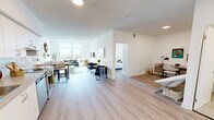Located at 2 River Plate St in Ajax, Ontario, this well-designed one-bedroom, one-bathroom unit offers a thoughtfully organized open-concept layout with clean, contemporary finishes throughout. Light-toned laminate flooring runs consistently across the space, contributing to a bright and cohesive aesthetic.

The kitchen and living area flow seamlessly together, making efficient use of the open floor plan. The kitchen features crisp white cabinetry extending to the ceiling for generous storage, a stainless steel refrigerator, dishwasher, and range, all set against a clean white tile backsplash and a functional countertop workspace.

The living room is anchored by large floor-to-ceiling windows that flood the space with natural light and offer open views of the surrounding Ajax skyline. The bright, neutral walls provide a versatile backdrop for any décor style.

The bedroom is a comfortable and private retreat, featuring a full-height sliding door closet and expansive windows with direct access to a balcony, offering additional outdoor views. The room benefits from excellent natural light throughout the day.

The bathroom is finished in an all-white palette, featuring a full-sized soaker tub with an overhead shower, tiled surround, and clean, functional fixtures. The overall ambiance of this unit is modern, light-filled, and efficiently designed for comfortable everyday living.