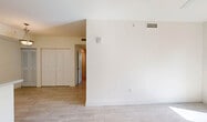 Located in Naranja, FL, this single-floor residence offers three bedrooms, two bathrooms, and a thoughtfully laid-out floor plan. Light-toned wood-look tile flooring runs consistently throughout all rooms, creating a cohesive and clean aesthetic.

The open-concept kitchen and living area serves as the heart of the home. The kitchen is equipped with stainless steel appliances, including a refrigerator, range, and over-the-range microwave, complemented by white cabinetry, a peninsula with a breakfast bar, and ample counter space. The adjoining living area is bright and open, with abundant natural light.

Three well-proportioned bedrooms offer generous closet storage — four closets are distributed across the unit — and the bedrooms feature large windows that frame views of the surrounding greenery. The primary bedroom is a comfortable, well-lit retreat.

Both bathrooms are finished with white cabinetry, clean countertops, and tub-shower combinations with tile surrounds. Additional conveniences include a dedicated laundry area, a utility room, and a private balcony. The overall design is clean, modern, and neutral, providing a bright and functional living environment.