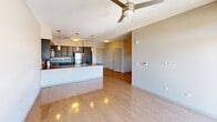 This contemporary 1-bedroom apartment in iLuminate #402, Phoenix, offers 790 square feet of thoughtfully designed living space. The open-concept layout seamlessly integrates the kitchen, living, and dining areas, creating a spacious feel. The kitchen boasts sleek cabinetry, quartz countertops, and stainless steel appliances, including a built-in microwave and electric range. Pendant lighting adds a touch of elegance.

The living area features hardwood floors and large windows that flood the space with natural light, offering stunning city views. A modern ceiling fan enhances air circulation. The bedroom, measuring 150 square feet, includes plush carpeting and a ceiling fan for comfort. The bathroom showcases a wide vanity with ample counter space, a large mirror, and contemporary fixtures.

Additional amenities include in-unit laundry and a closet for storage. The apartment's neutral color palette and clean lines create a sophisticated ambiance, perfect for urban living in the heart of Phoenix.