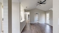 This 860 square foot apartment in Kennesaw, GA offers a harmonious blend of modern design and practical living. The space features two bedrooms and two bathrooms, making it perfect for small families or those seeking a guest room. The open-concept living area is anchored by a sleek fireplace with white tile surround, creating a cozy focal point.

The kitchen boasts contemporary white cabinetry, stainless steel appliances, and a hexagonal tile backsplash, lending a touch of geometric interest. A central island with a sink provides additional prep space and casual dining options. The living room flows seamlessly into the dining area, enhanced by large windows that invite natural light.

Both bedrooms offer ample space, with the primary bedroom measuring 140 square feet. Plush carpeting in the bedrooms contrasts with the durable wood-look flooring in the main living areas. The bathrooms feature modern vanities with sleek hardware and large mirrors, creating a spa-like atmosphere.

Throughout the apartment, neutral tones dominate, allowing for personalization. Ceiling fans and modern lighting fixtures add both functionality and style. Built-in closets with louvered doors provide generous storage options. The apartment's layout, as seen in the 3D floor plan, showcases an efficient use of space, ensuring a comfortable and contemporary living experience.
