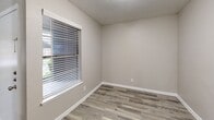 Located at 601 W Renner Rd in Richardson, TX, this single-story, 2-bedroom, 2-bathroom home offers a well-designed layout with a cohesive neutral palette throughout. The living area is highlighted by striking vaulted ceilings that create an airy, open atmosphere, complemented by large windows that allow abundant natural light and views of the outdoors. Durable wood-look plank flooring flows through the main living areas, dining room, and hallway, providing a clean, modern aesthetic.

The kitchen features granite-style countertops, a double stainless steel sink with a contemporary pull-down faucet, and stylish pendant lighting overhead. A pass-through counter connects the kitchen to the dining area, enhancing the open-concept feel. A hallway leads to both bedrooms and two full bathrooms. The primary bedroom offers a ceiling fan, a closet, and soft carpeting underfoot. The second bedroom also benefits from natural light via a window with blinds and matching plank flooring. Each bathroom is finished with granite-style vanity countertops and includes a tub-shower combination. Two closets provide practical storage throughout the home.
