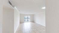 Located at 4400–4550 W 16th Ave in Hialeah, FL, Unit 616 is a well-appointed 3-bedroom, 2-bathroom residence thoughtfully laid out across a single floor. Light-toned ceramic tile flooring runs throughout, creating a cohesive and easy-to-maintain aesthetic. The combined kitchen and living area serves as the heart of the home, featuring a sleek kitchen with white cabinetry, quartz countertops, stainless steel appliances including a range, microwave, and refrigerator, and a peninsula with an integrated sink — ideal for both cooking and casual dining. The living area is open and airy, accented by crown molding and a textured ceiling. A sliding glass door leads to a private balcony with open views of the surrounding community. The primary bedroom is generously sized, offering an en-suite bathroom and direct access to a closet. Two additional bedrooms provide ample space, each with access to hallways and closet storage. Both bathrooms are finished in crisp white, featuring tub-shower combinations and tile flooring. Two hallways connect the rooms efficiently, enhancing flow throughout the unit. The overall ambiance is clean, bright, and move-in ready.