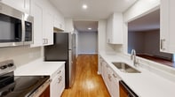Step into a world of elegance and comfort in this exquisite 2-bedroom, 2-bathroom haven at Astor Premier. Boasting 1030 square feet of thoughtfully designed living space, this home is your gateway to a life of luxury and convenience.

As you enter, you're greeted by the warm glow of pristine hardwood floors that flow seamlessly throughout, creating a sense of continuity and sophistication. The open-concept living area is a testament to modern design, offering a blank canvas for your personal style and the perfect backdrop for both relaxation and entertainment.

The heart of this home is the stunning kitchen, a culinary enthusiast's dream. Crisp white cabinetry contrasts beautifully with sleek stainless steel appliances, while ample counter space invites you to explore your culinary passions. The kitchen's clever design ensures that preparing meals is a joy, not a chore.

Retreat to the primary bedroom, a spacious 200 square foot sanctuary that promises restful nights and peaceful mornings. Large windows invite natural light to dance across the room, creating an airy and uplifting atmosphere. The en-suite bathroom offers a private oasis for your daily rituals.

This home is not just about indoor comfort; it's about embracing the outdoors too. Sliding glass doors lead to a private balcony, your personal slice of the outside world where you can sip morning coffee or enjoy evening cocktails while basking in the fresh air.

With its prime location in North Andover, this property at 50 Royal Crest Drive places you at the heart of convenience while offering a tranquil retreat from the bustle of daily life. The thoughtful layout, modern amenities, and attention to detail make this more than just a house – it's a lifestyle upgrade waiting for you to call it home.