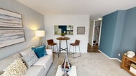 Located at 400 E 33rd St in Chicago's Bronzeville neighborhood, this single-floor residence offers a thoughtfully designed layout with a cohesive contemporary aesthetic throughout. The living area is defined by plush carpeting, soft neutral tones, and accent walls in a muted blue-gray palette. A pass-through window connects the living space to the kitchen, enhancing the open feel of the unit. The room comfortably accommodates both a seating area and a bistro-style dining setup, making it versatile for everyday living and entertaining.

The kitchen features white cabinetry, a gas range with wall oven, a double sink, and a full-size refrigerator. Wood-look flooring and a bold teal accent wall add visual interest, while ample overhead cabinet storage ensures practical functionality.

The bedroom is a serene retreat, highlighted by a striking teal gradient accent wall, carpet flooring, and a large window with vertical blinds that allows natural light to filter in. A walk-in closet provides generous storage space.

The bathroom includes a pedestal sink, a tub-shower combination, a mirrored medicine cabinet, and globe vanity lighting, maintaining a clean, classic look. Overall, the unit presents a cohesive and livable space with modern styling throughout.