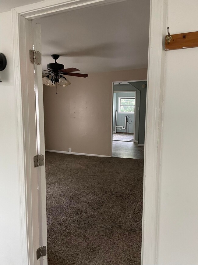 Looking from entry hall to living room and kitchen beyond - 120 Holly St
