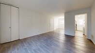 Located at 3167 Chestnut Dr in Doraville, GA, this well-appointed 2-bedroom, 2-bathroom single-story home offers a clean, modern aesthetic throughout. The open living and dining area is anchored by rich hardwood-style flooring and large windows that invite natural light, creating a bright and welcoming atmosphere. A hallway connects the main living spaces seamlessly to the rest of the home.

The kitchen is thoughtfully updated with white shaker-style cabinetry, marble-look countertops, light wood-style flooring, and a full suite of stainless steel appliances, including a refrigerator and electric range with overhead ventilation. Adjacent to the kitchen, the dining area benefits from a window-lit entry door, adding to the home's airy feel.

Both bedrooms feature plush carpeting for comfort underfoot. The primary bedroom is generously sized, equipped with a ceiling fan, natural light from a window, and an expansive set of bifold closet doors offering substantial storage. The second bedroom is equally well-lit and functional.

The two bathrooms are finished in a crisp white palette, each featuring a tub-shower combination, marble-look vanity countertops, white cabinetry, and wood-style flooring. Together, the spaces reflect a cohesive, updated design that balances practicality with modern style.